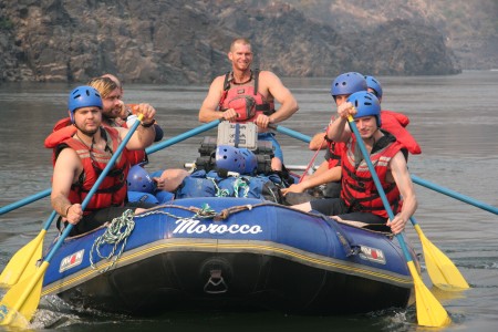 Jack Osbourne and Elijah Wood with pelicases and drybags on the raft