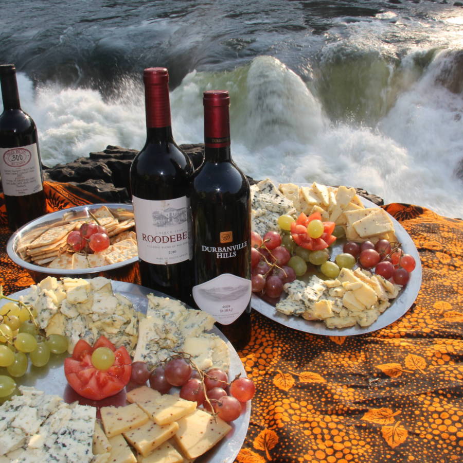 Image of wine and cheese board overlooking Moemba Falls, Zambezi River