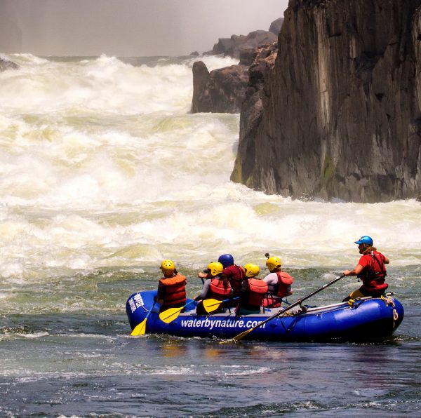 Raft with paddler in front of the minus rapids on the Zambezi River