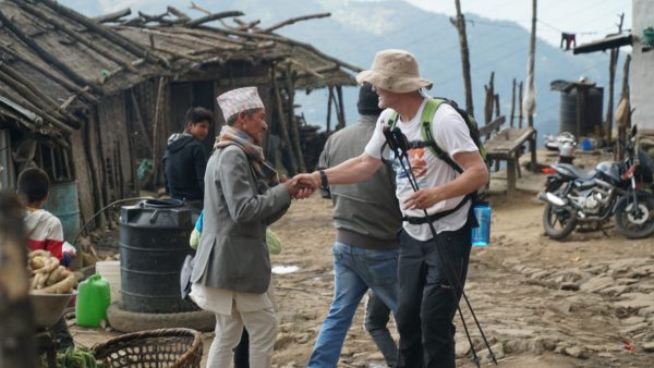Nepali man shaking hands with westerner