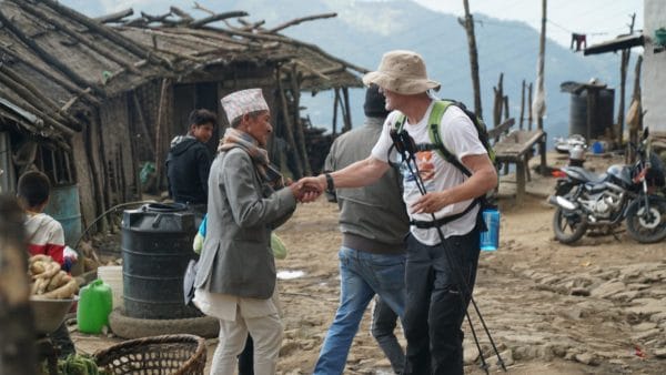 Nepali man shaking hands with westerner