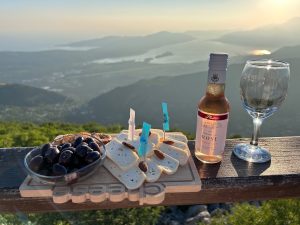 Cheese and wine served with views at sunset over Boka Bay, Montenegro