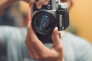 Close up of someone holding a Nikon camera