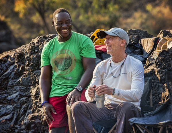 Guide chatting to client on rafting trip